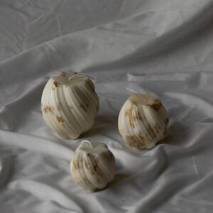 Twirling pillar candles “with golden finish”