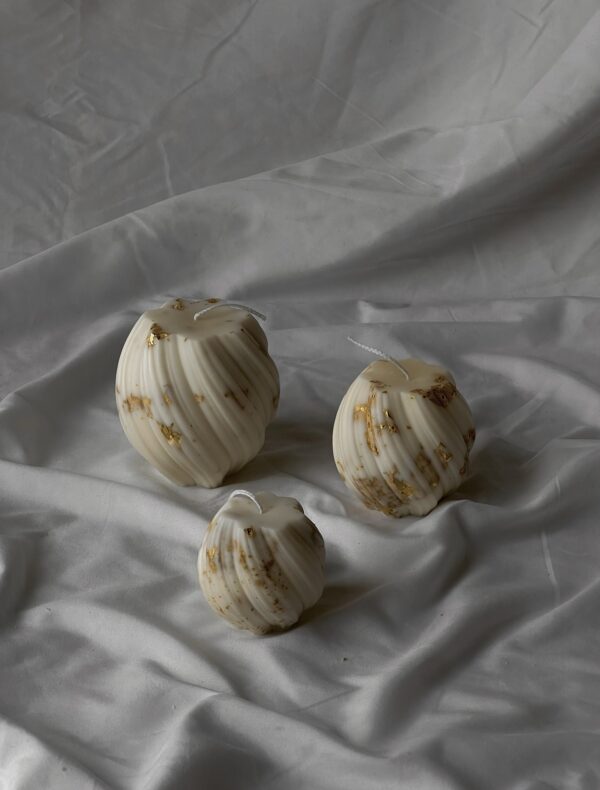 Twirling pillar candles “with golden finish”